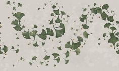 green leaves are flying in the air on a white background with gold flecks