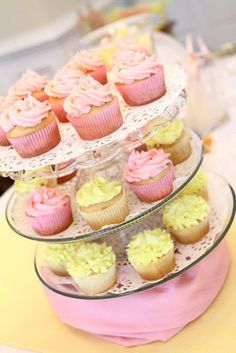 three tiered trays with cupcakes on them