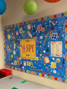 a colorful bulletin board with lots of school supplies on it and hanging from the ceiling