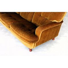 a brown couch sitting on top of a white floor