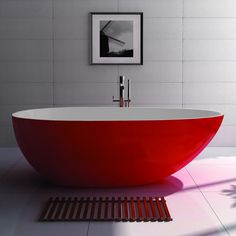 a red bath tub sitting on top of a white floor