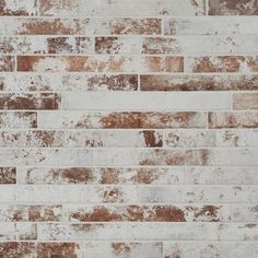 an old brick wall with peeling paint and chippings on the edges is shown