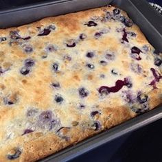 a pan filled with blueberry cobble sitting on top of a stove