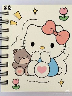 an open notebook with hello kitty and teddy bear on it