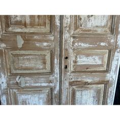 an old wooden door with peeling paint on it