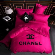 a chanel bed with pink sheets and pillows