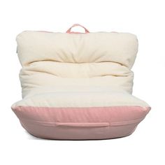 a pink and white pillow sitting on top of a chair with the back cushion folded down