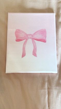 a pink bow painted on a white canvas