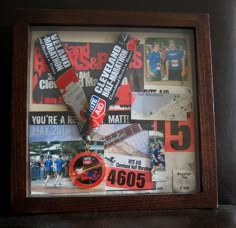 a wooden frame holds a medal and sports memorabilia