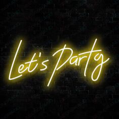 a neon sign that says let's party on the side of a brick wall