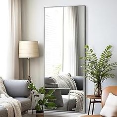 a living room filled with furniture and a large mirror in the middle of the room