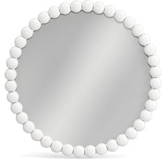 a round mirror with white beads around it