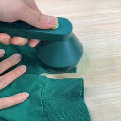 someone using a green cloth to clean their shoes