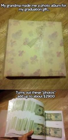 an open book sitting on top of a wooden table next to a pile of money