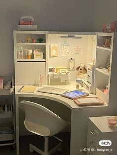 a white desk with a laptop on top of it next to a shelf filled with items