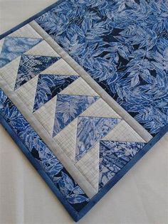 a blue and white quilted table runner