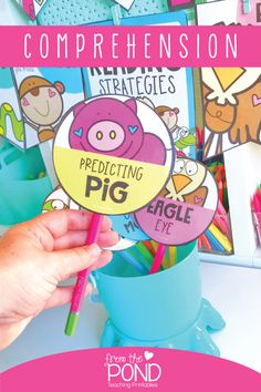 a person holding up a cup full of pencils with the words pig on it