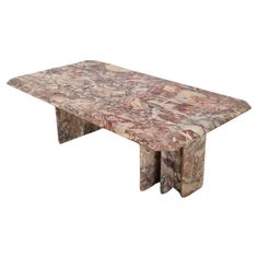 a marble table with two legs and a large slab on the top, it is made out of wood