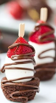 chocolate covered desserts with strawberries on top