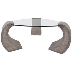 a glass and stone coffee table with an arch design on the top, against a white background