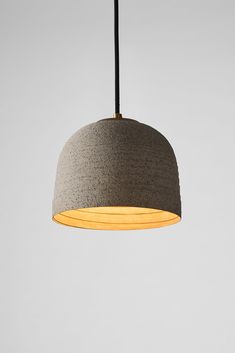 a gray and yellow light hanging from a ceiling