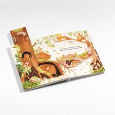 an open children's book with pictures of animals in the woods and trees on it