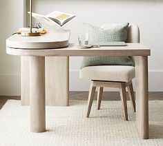 a table with a chair and a book on it