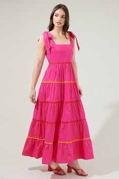 You will love the Hannah Hall Tiered Maxi Dress as much as we do! This pretty maxi dress has a square neckline followed by tied straps on the top that sits on a tiered maxi skirt. A smocked back and invisible zipper adorn the back. Perfect for a nice sunny day! - Tiered- Tie strap- Smocked- Zipper- Color: FuchsiaSize + Fit - Model is 5'8" and wearing size XS- Measurements taken from size S - Chest: 16 3/4"- Length: 47" Fabric Self:100% Cotton Lining:97% Polyester 3% Spandex Style Number STD13960 Pretty Maxi Dress, Tiered Maxi Skirt, Tiered Maxi Dress, Sunny Day, Invisible Zipper, Summer Wear, Square Neckline, Sundress