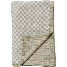 a white and grey checkered blanket folded up