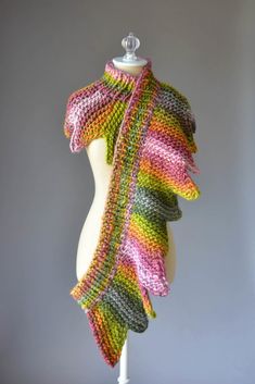 a multicolored knitted shawl on a mannequin