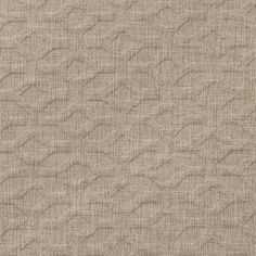 an upholstered beige fabric with wavy lines