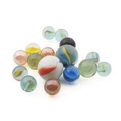 several different colored marbles sitting on top of each other in the middle of a white background