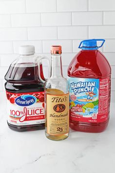 ingredients to make hawaiian punch on a marble countertop with white tiles in the background