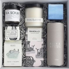 an open box containing various items such as candles, soaps and lotions