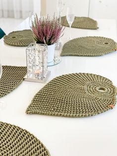 crochet placemats on a white table with purple flowers in the center