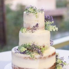 a three tiered cake with flowers on top