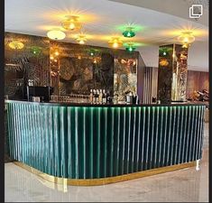 the interior of a restaurant with green and gold decor on the walls, along with marble flooring