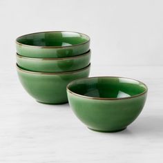 three green bowls sitting next to each other