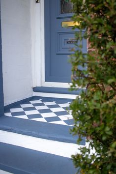 a blue front door with a checkered floor