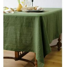 a green table cloth on top of a wooden table