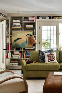 a living room filled with furniture and bookshelves