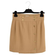 Chanel skirt circa 1990 mini in camel wool cloth, "wrap" style closed by 4 clover buttons at the waist and 4 over the entire height, matching silk lining. No more composition or size label but the measurements indicate a 36FR: size 36 cm, length 41 cm. The skirt is vintage, the skirt has been shortened and the waist has probably been retouched or the waist buttons moved (it was originally supposed to be bigger) but it is in very good condition, perfect for every day, with sneakers or chelsea boo Dior Skirt, Green Maxi Skirt, Chanel Skirt, Vintage Chanel Bag, Colored Tights, Wrap Mini Skirt, Chanel Mini, Wool Wrap, Green Maxi