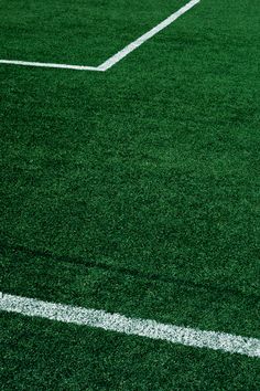 an empty soccer field with white lines on it