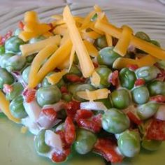 a green plate topped with grapes and cheese