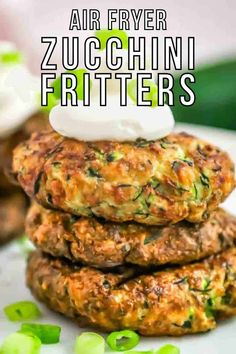 three zucchini fritters stacked on top of each other with text overlay that reads air fryer zucchini fritters