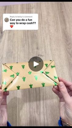 someone is holding an envelope with green christmas trees on it and the message can you do fun way to wrap cash?