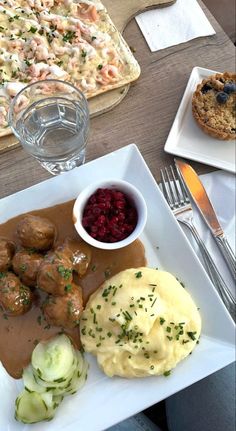 a white plate topped with meatballs and mashed potatoes