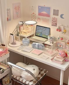 a white desk topped with a laptop computer