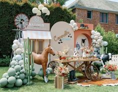 a horse is standing in front of a table with balloons and decorations on the lawn