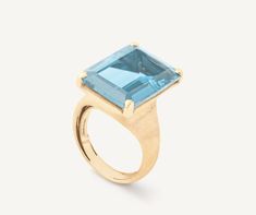 MURANO 18K Yellow Gold Blue Topaz Cocktail Ring Topaz Cocktail Ring, Yellow Gold Cocktail Ring, Gold Skies, Gold Cocktail Ring, Gold Cocktail, Jewelry Techniques, Blue Springs, Branded Gifts, Baguette Cut